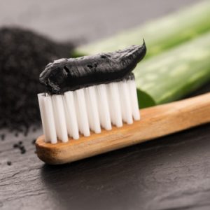 Toothbrush with black charcoal toothpaste 