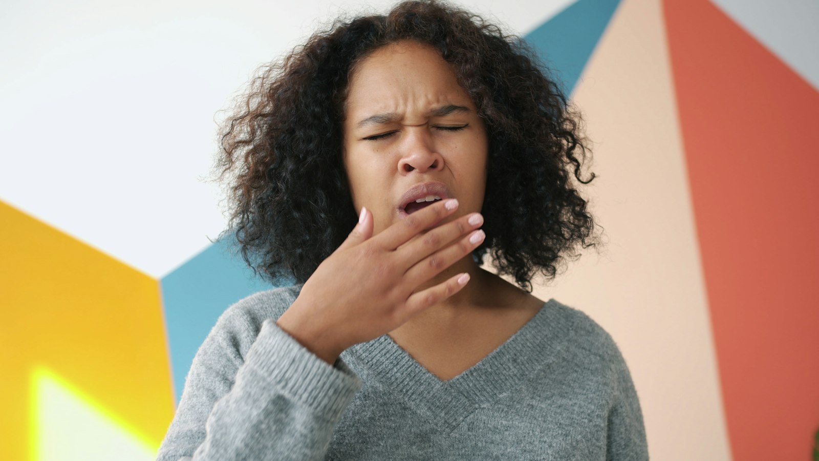freestocks-Qx5QNarbrUM-unsplash Young woman yawning with hand over mouth